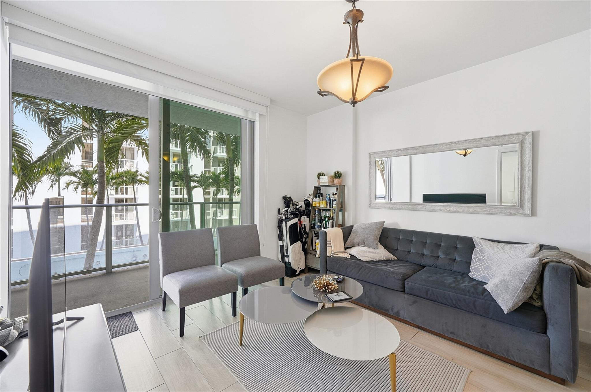1600 Southwest 1st Avenue, Unit 510 Miami, FL 33129 - Photo 15 of 75 a living room with furniture and a chandelier