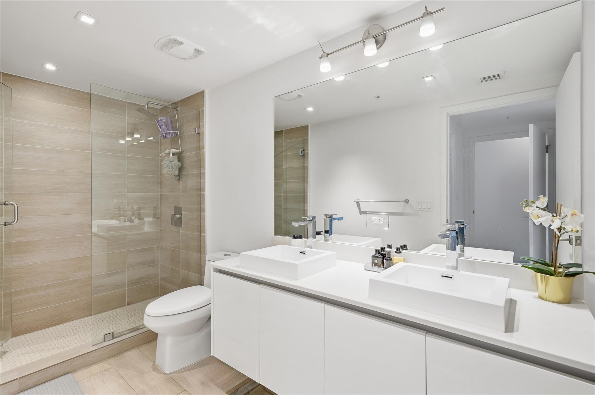 1600 Southwest 1st Avenue, Unit 510 Miami, FL 33129 - Photo 22 of 75 a bathroom with a sink shower and a toilet