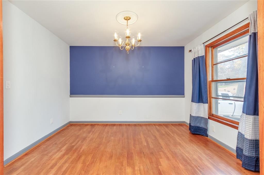 4424 Locksley Road Tucker, GA 30084 - Photo 12 of 50 a view of an empty room with wooden floor and a window