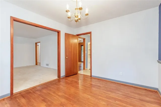 a kitchen with cabinets stainless steel appliances and a chandelier
