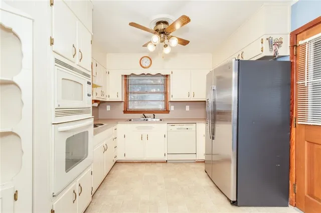 a kitchen with cabinets and window