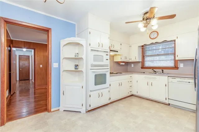 a kitchen with granite countertop cabinets stainless steel appliances and a sink