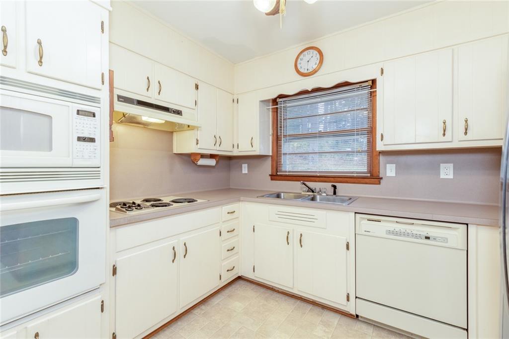 4424 Locksley Road Tucker, GA 30084 - Photo 18 of 50 a kitchen with granite countertop cabinets stainless steel appliances and a sink