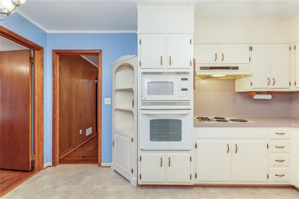 4424 Locksley Road Tucker, GA 30084 - Photo 19 of 50 a kitchen with stainless steel appliances granite countertop a stove and a refrigerator with white cabinets