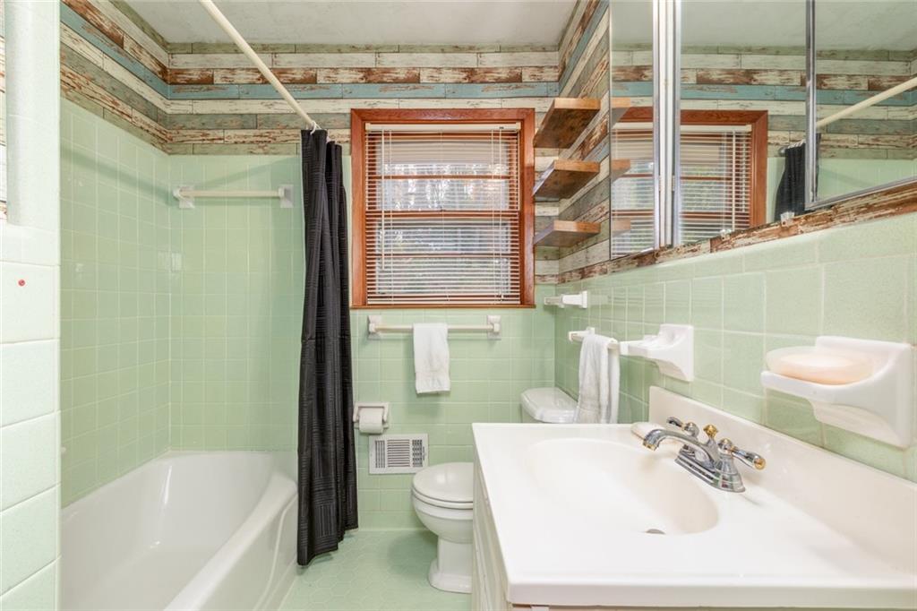 4424 Locksley Road Tucker, GA 30084 - Photo 26 of 50 a bathroom with a sink a toilet and shower