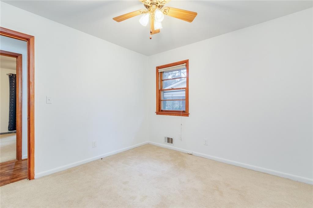4424 Locksley Road Tucker, GA 30084 - Photo 28 of 50 an empty room with a chandelier fan