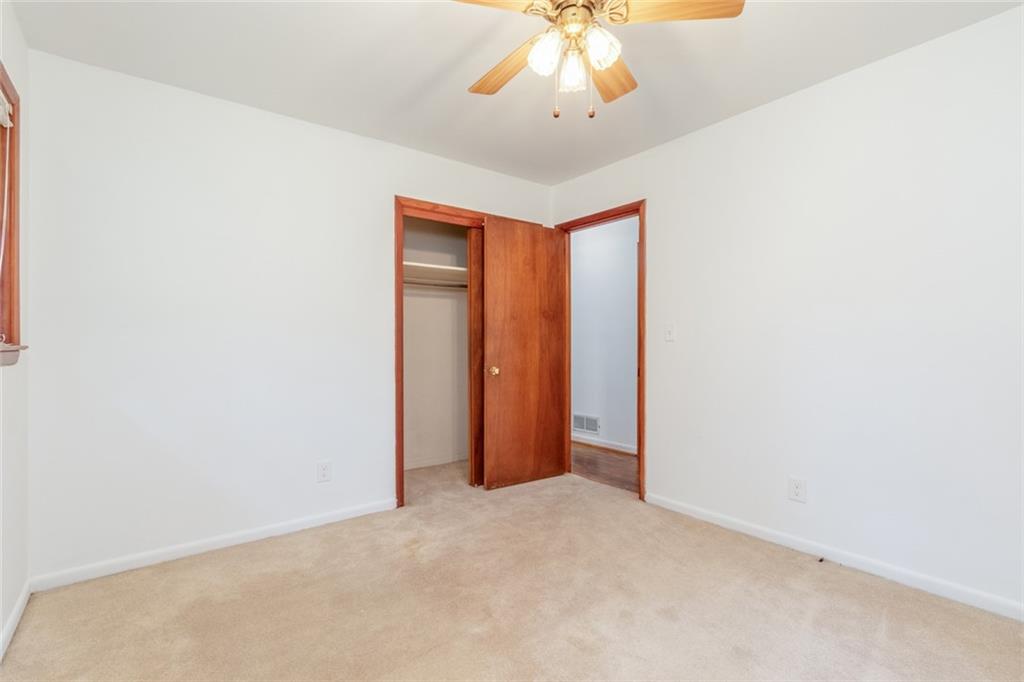 4424 Locksley Road Tucker, GA 30084 - Photo 29 of 50 an empty room with a chandelier fan