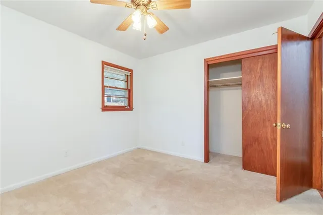 an empty room with windows and closet