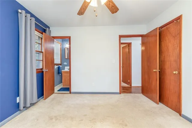 a view of entryway and hall with a chandelier fan