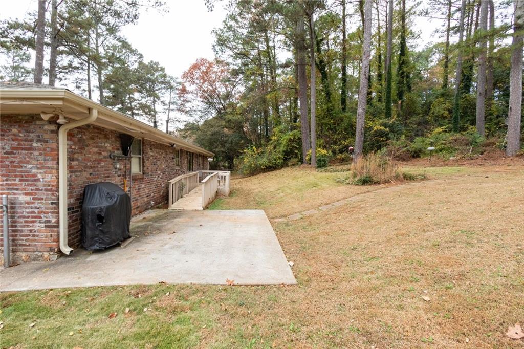 4424 Locksley Road Tucker, GA 30084 - Photo 39 of 50 a view of a backyard with large trees