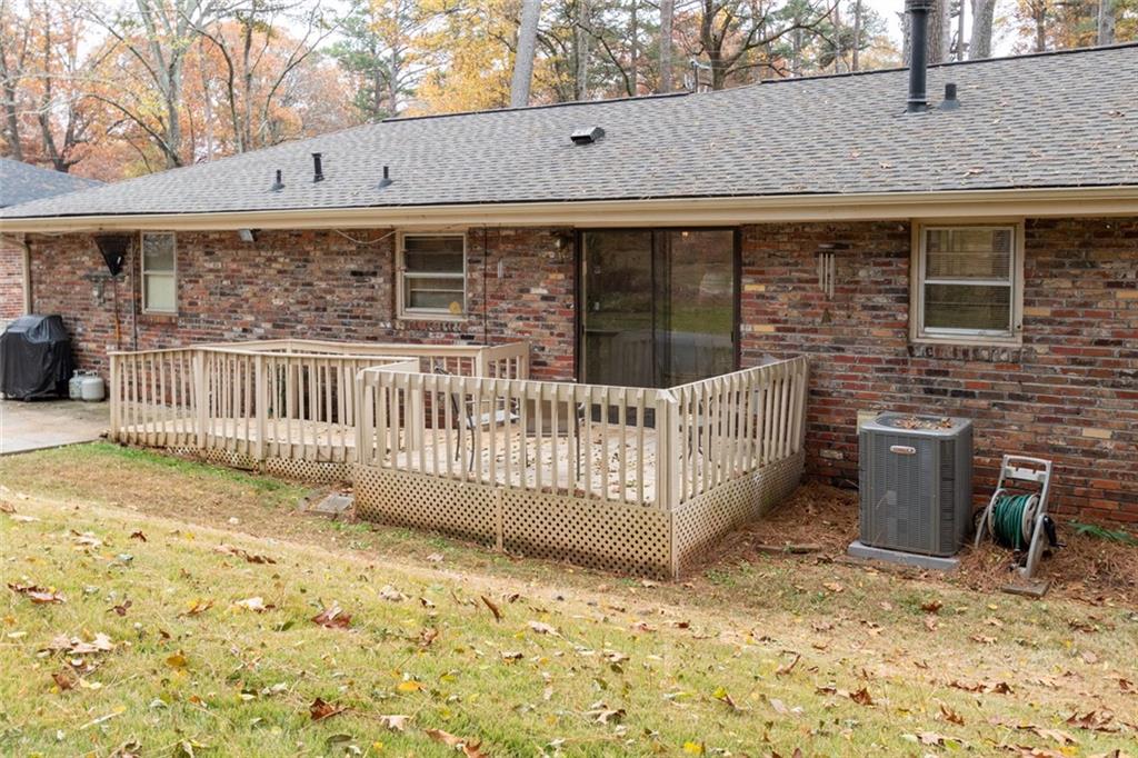 4424 Locksley Road Tucker, GA 30084 - Photo 44 of 50 a view of a house with a wooden deck and furniture