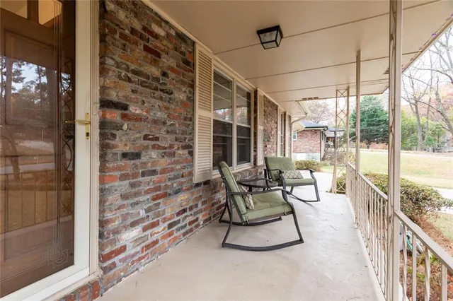 a view of a balcony with chair and table in the balcony