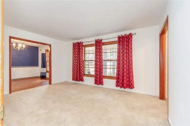 a view of a room with window and a bed