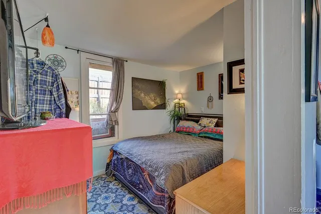 a bedroom with bed and window