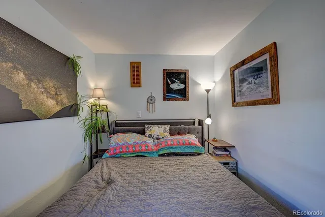 a bedroom with a bed and a couch