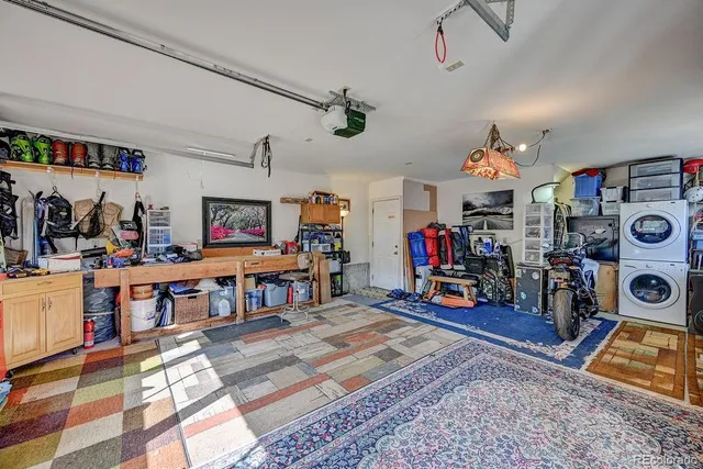 a view of a play room with clothes and a rug