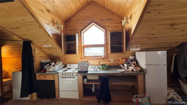 a kitchen with stainless steel appliances kitchen island granite countertop a refrigerator and a stove