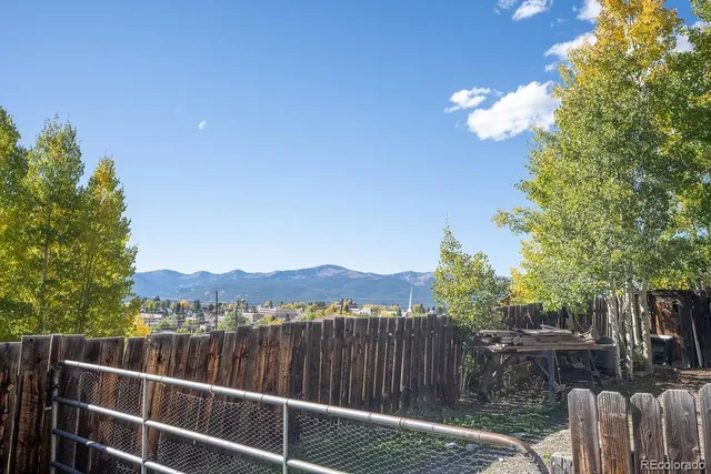 a view of a green field with wooden fence