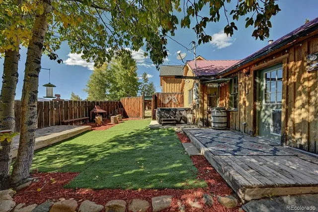 a view of a porch with furniture and a yard