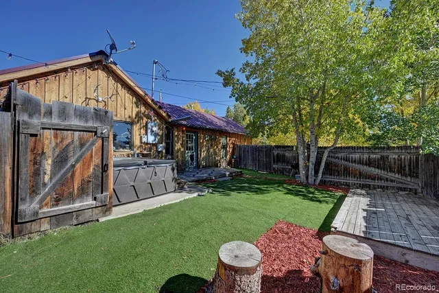 a view of a chair and table in backyard of the house