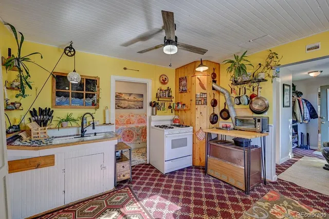 a kitchen with stainless steel appliances a stove a sink and a refrigerator