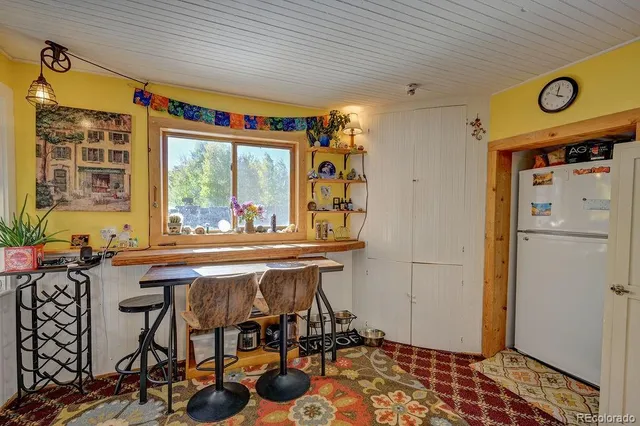a view of a dining room with furniture and window