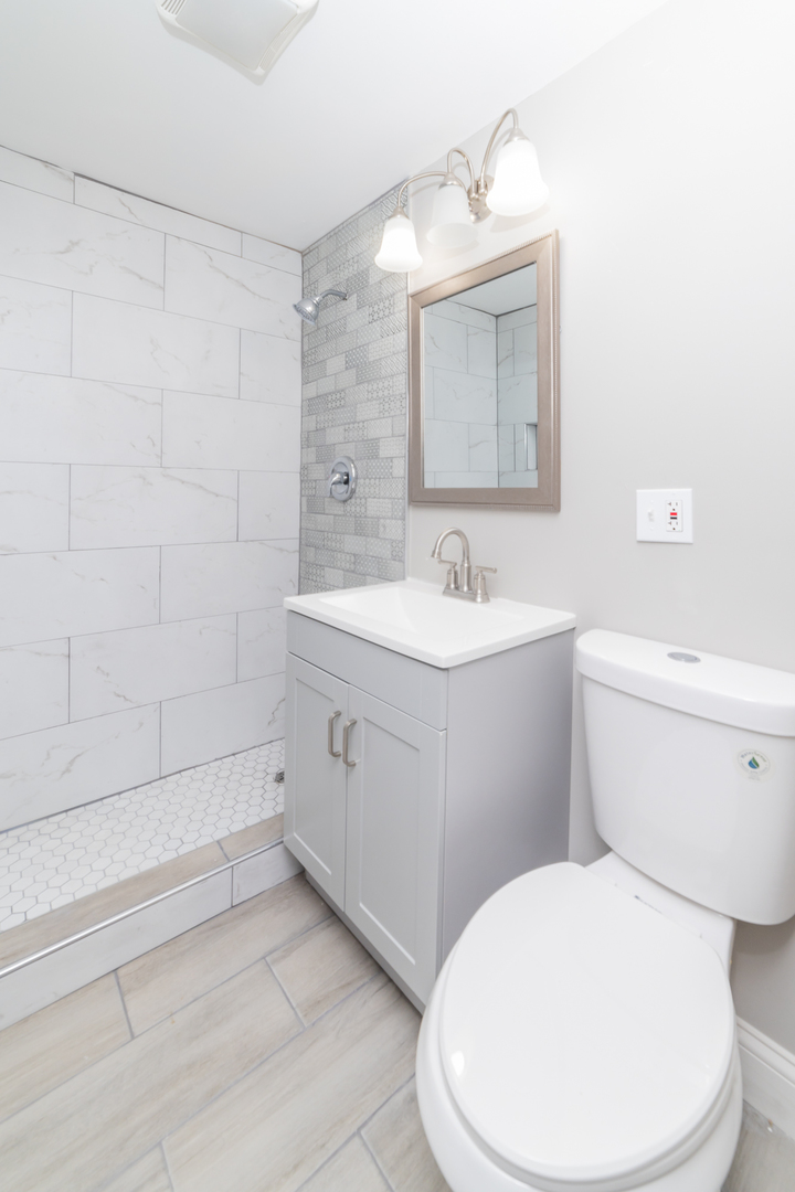 7227 South Indiana Avenue Chicago, IL 60619 - Photo 19 of 21 a white toilet sitting next to a bathroom sink