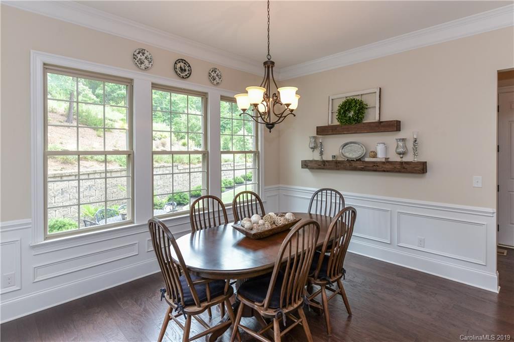 615 Pomegranate Place Fort Mill, SC 29708 - Photo 11 of 34 a dining room with furniture a large window and wooden floor