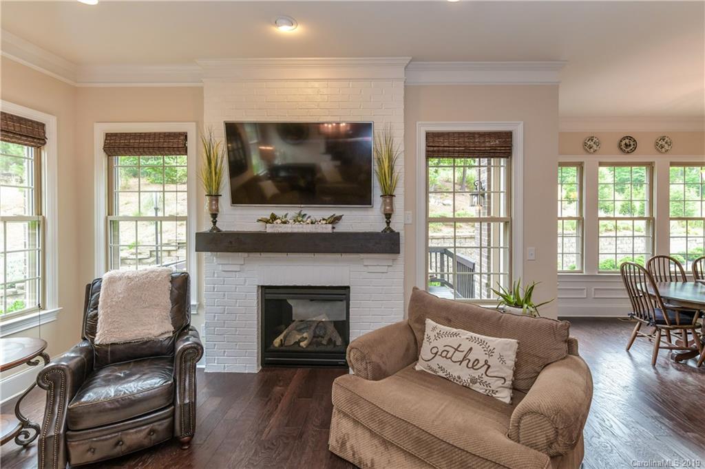 615 Pomegranate Place Fort Mill, SC 29708 - Photo 13 of 34 a living room with furniture a flat screen tv and a fireplace