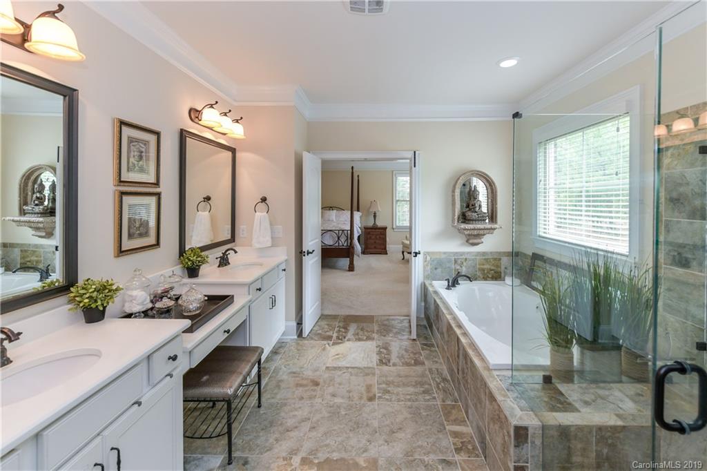 615 Pomegranate Place Fort Mill, SC 29708 - Photo 17 of 34 a spacious bathroom with a granite countertop sink mirror and a bath tub
