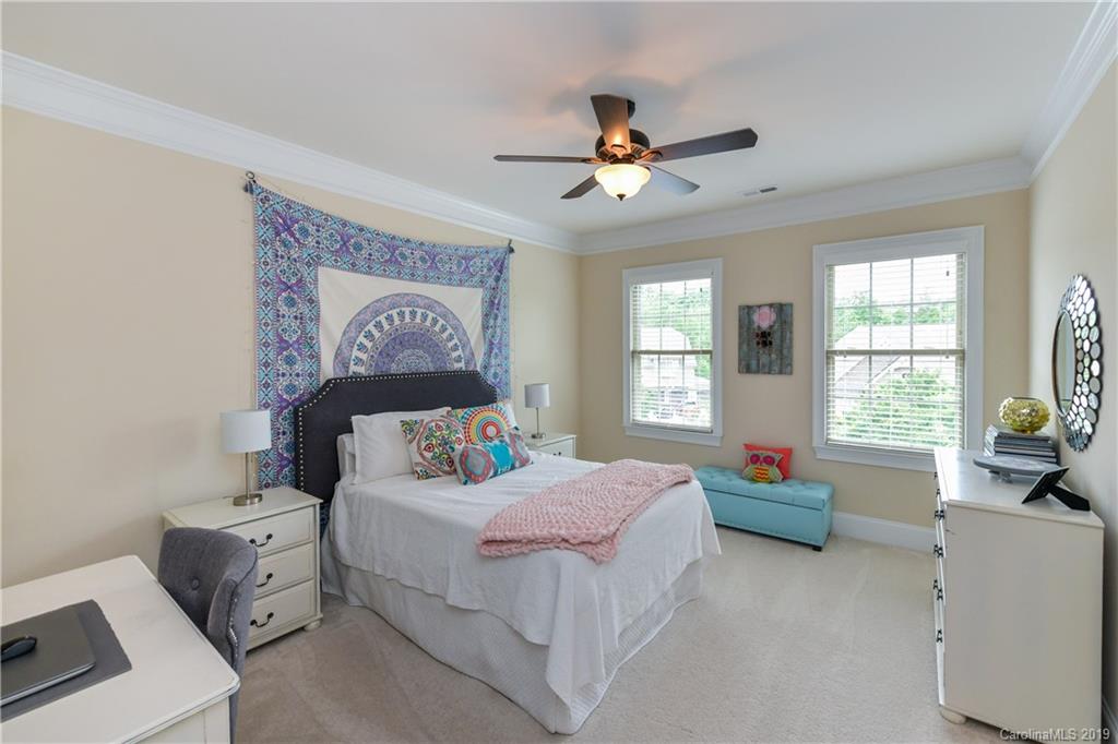 615 Pomegranate Place Fort Mill, SC 29708 - Photo 21 of 34 a bedroom with a bed and a chandelier