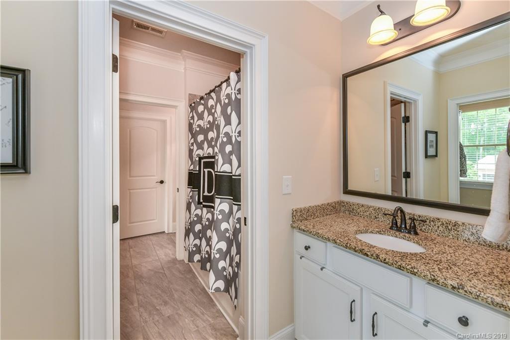 615 Pomegranate Place Fort Mill, SC 29708 - Photo 23 of 34 a bathroom with a granite countertop sink and a mirror