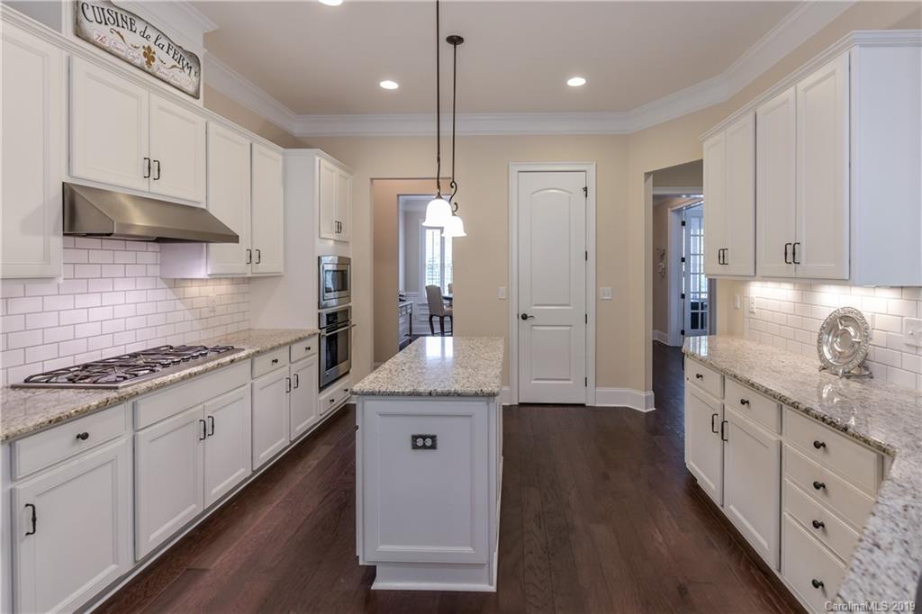 615 Pomegranate Place Fort Mill, SC 29708 - Photo 9 of 34 a kitchen with granite countertop a sink a counter space appliances and cabinets