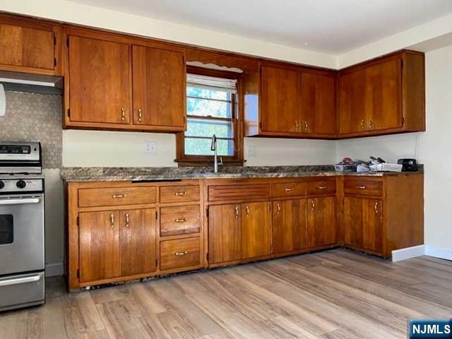 175 Delafield Avenue, Unit 2 Lyndhurst, NJ 07071 - Photo 5 of 7 a kitchen with granite countertop wooden cabinets a sink and dishwasher