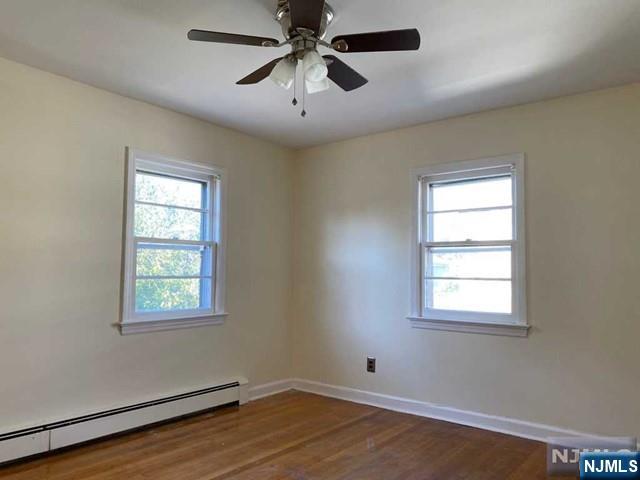 175 Delafield Avenue, Unit 2 Lyndhurst, NJ 07071 - Photo 7 of 7 an empty room with windows and fan