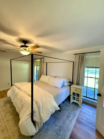 a bedroom with a bed and a window