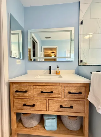 a bathroom with a sink and a mirror