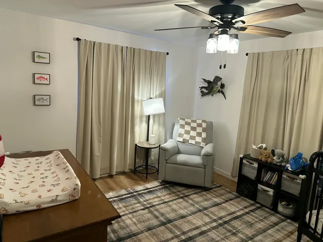 a bedroom with furniture and a window