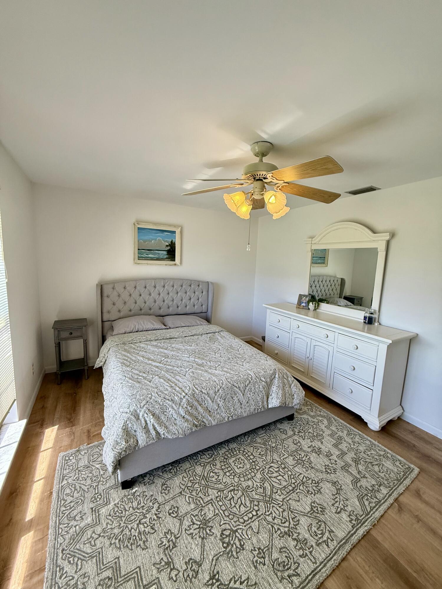 411 West Avenida Del Rio Clewiston, FL 33440 - Photo 21 of 29 a bedroom with a bed and wooden floor