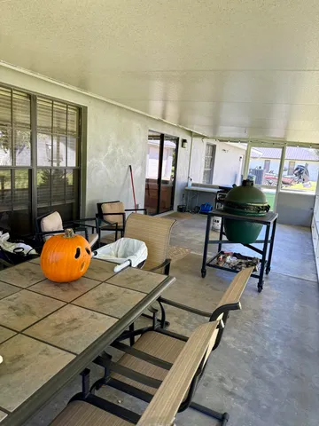a room with furniture pool table and windows