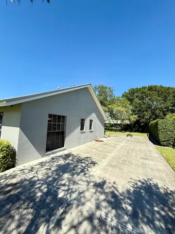 a backyard of a house with a yard and garage