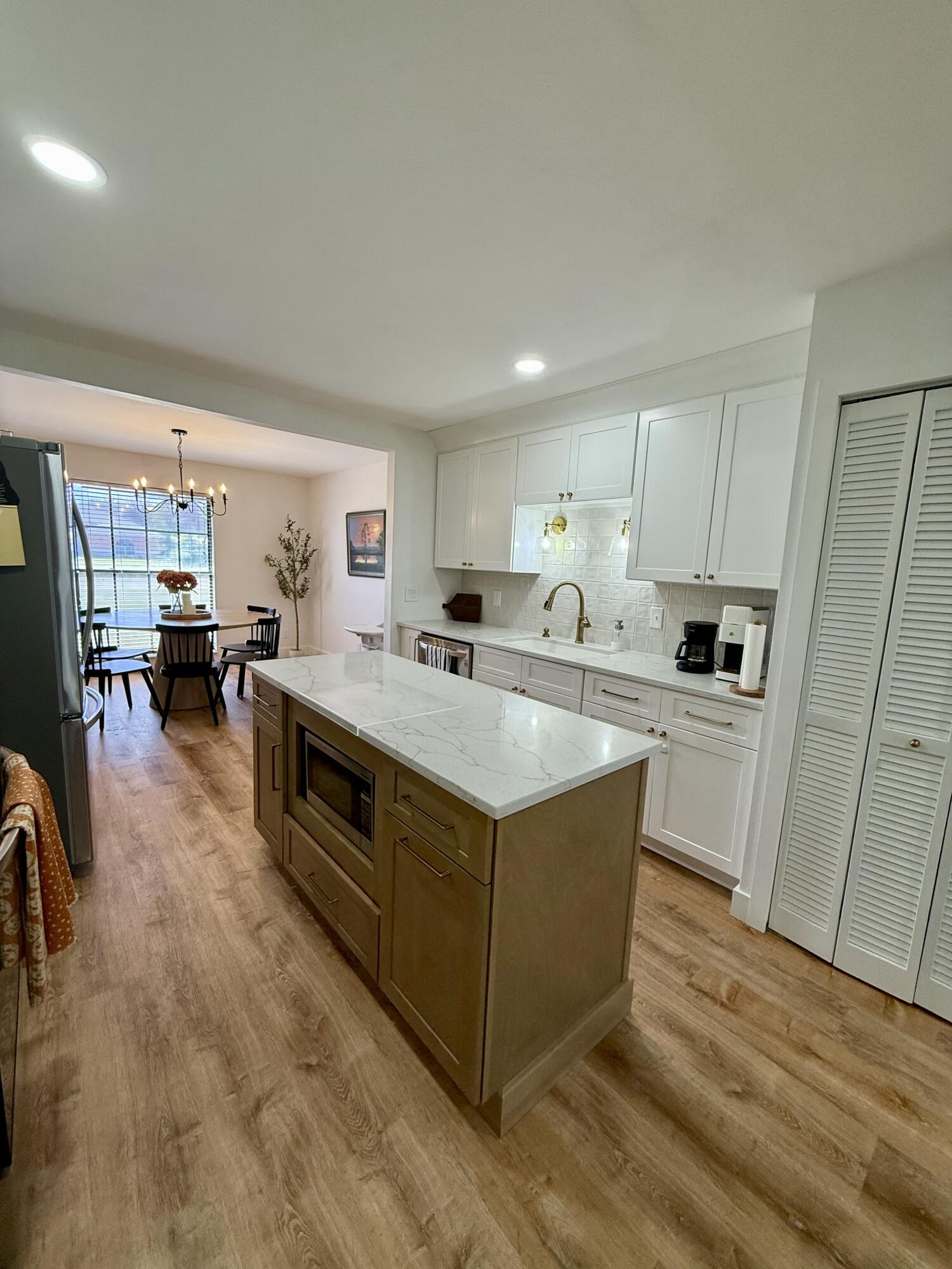 411 West Avenida Del Rio Clewiston, FL 33440 - Photo 6 of 29 a kitchen with stainless steel appliances a sink a stove a refrigerator cabinets and a window