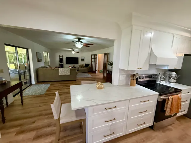 a kitchen with sink cabinets and living room