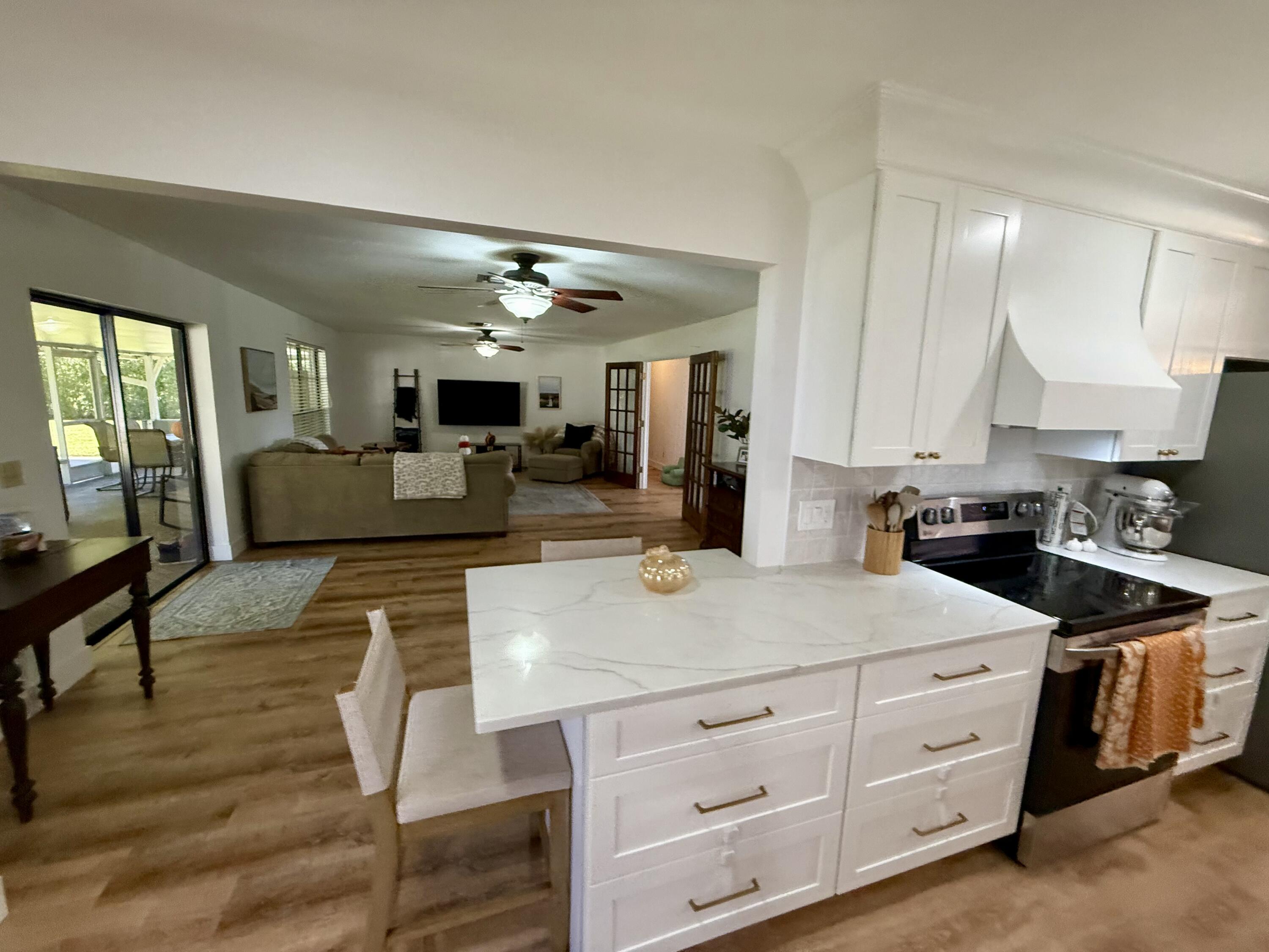 411 West Avenida Del Rio Clewiston, FL 33440 - Photo 8 of 29 a kitchen with sink cabinets and living room