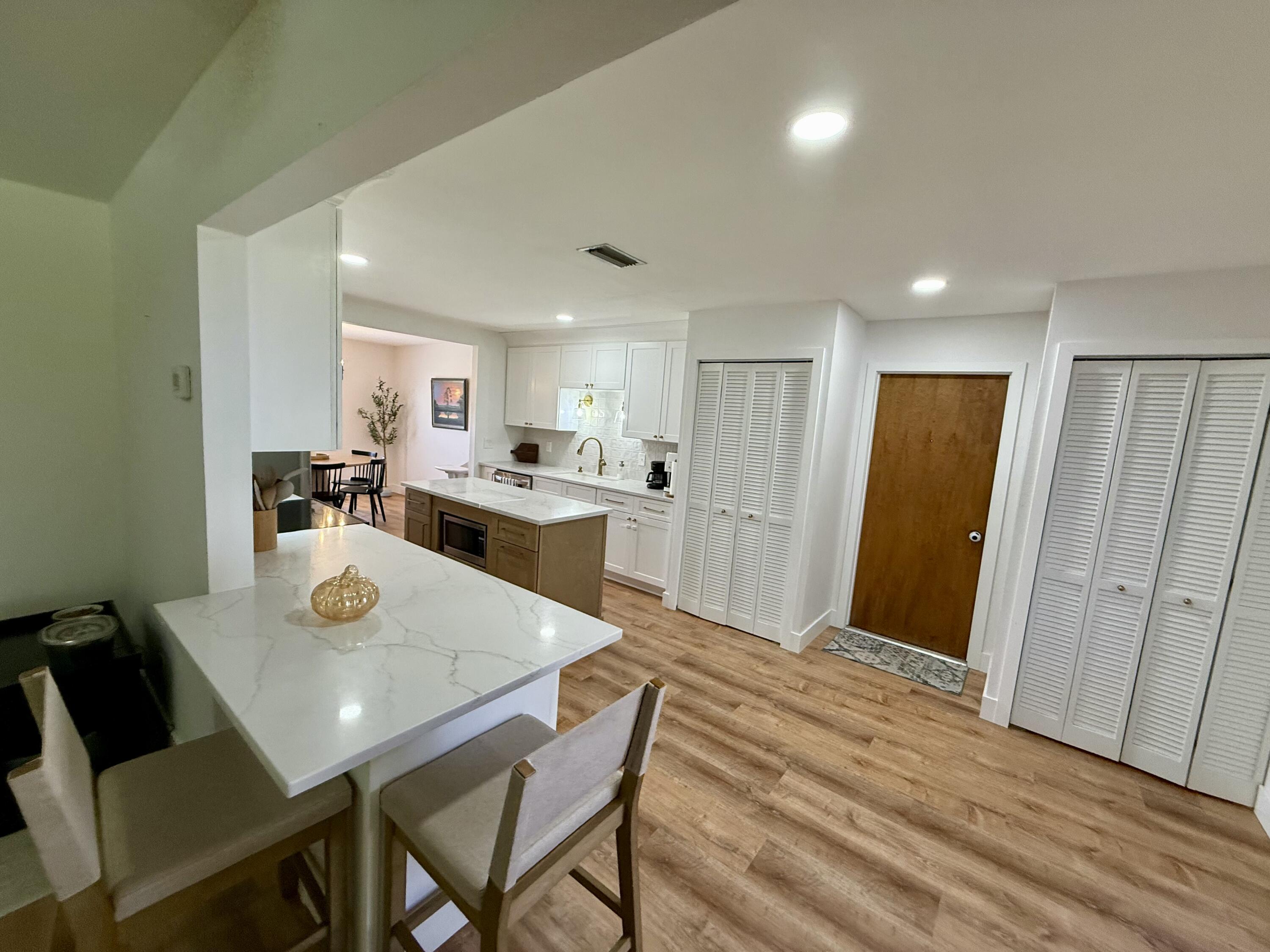 411 West Avenida Del Rio Clewiston, FL 33440 - Photo 9 of 29 a view of a dining room with furniture and wooden floor