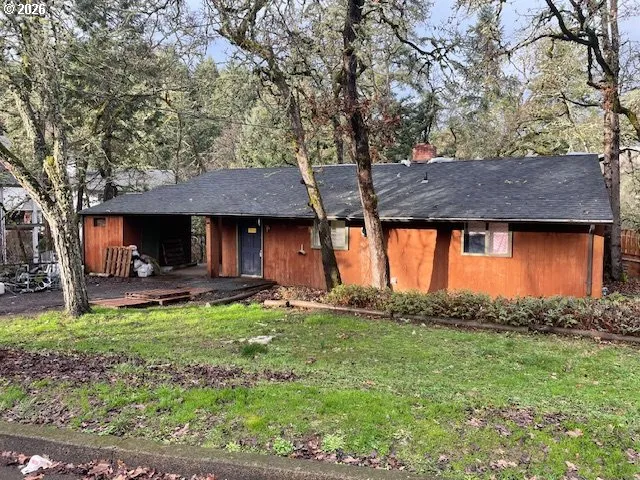 a view of a house with a yard and sitting area
