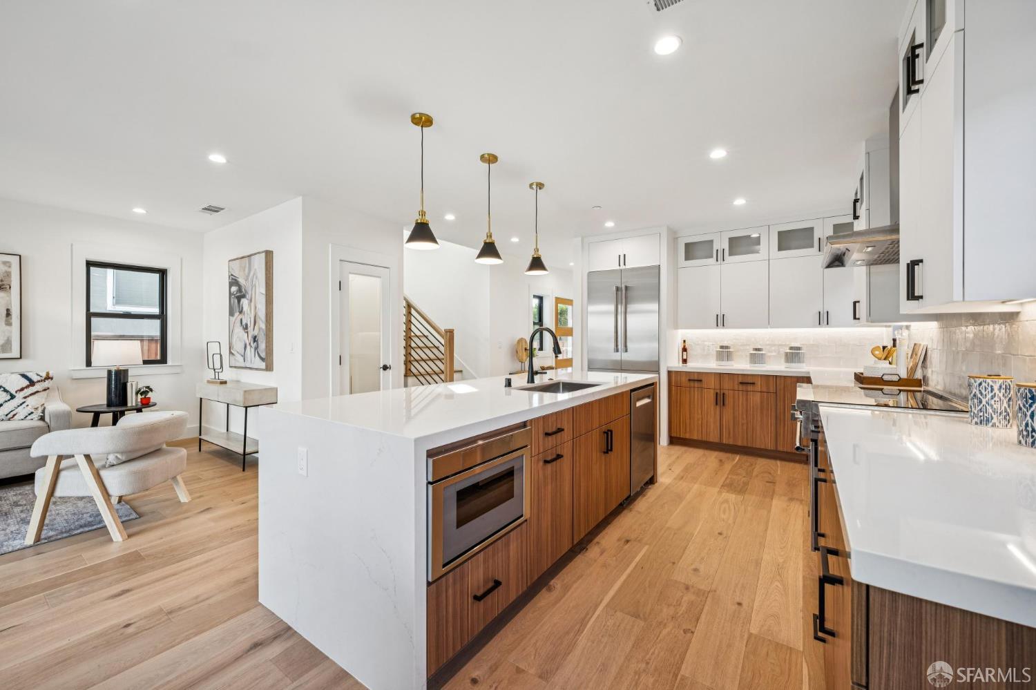 2411 Sixth Street Berkeley, CA 94710 - Photo 25 of 72 a large kitchen with stainless steel appliances kitchen island granite countertop a large kitchen island a stove a sink a refrigerator and white cabinets with wooden floor