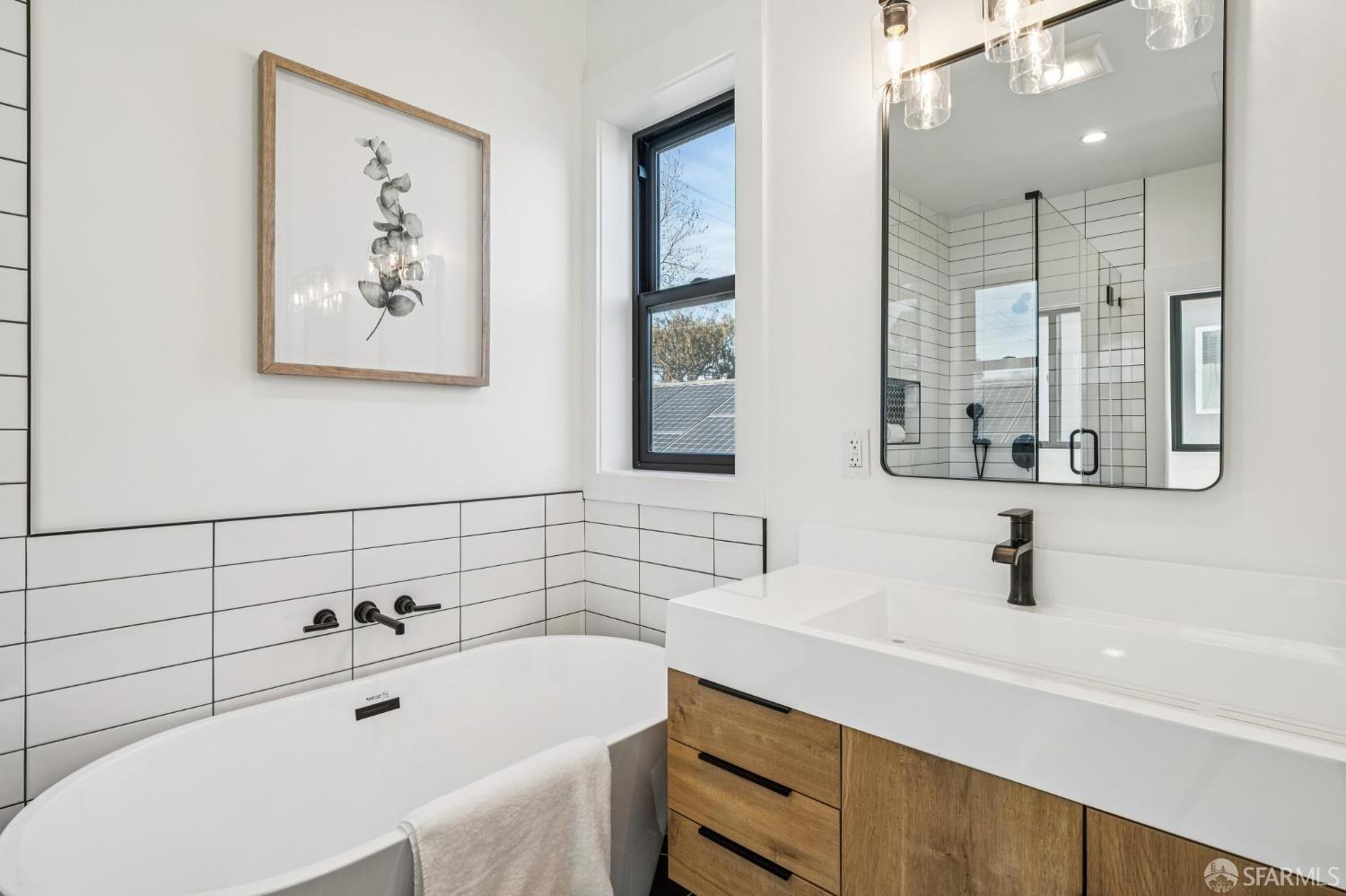 2411 Sixth Street Berkeley, CA 94710 - Photo 43 of 72 a bathroom with a tub sink and mirror