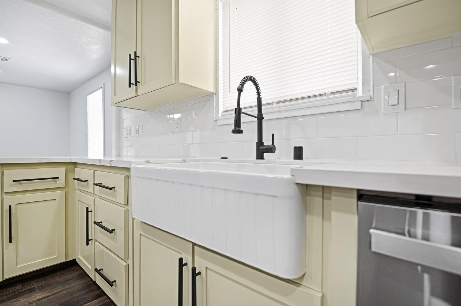 325 West Bush Street Lemoore, CA 93245 - Photo 13 of 55 a kitchen with white cabinets and sink
