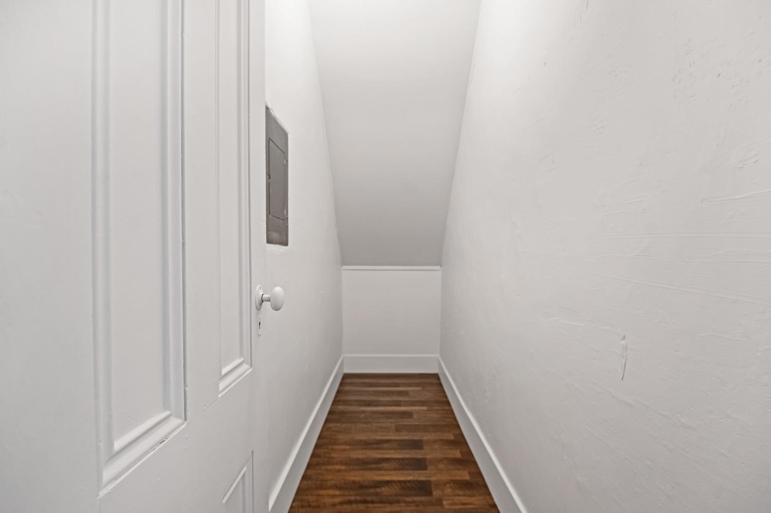 325 West Bush Street Lemoore, CA 93245 - Photo 30 of 55 a view of a hallway with wooden floor and a bathroom